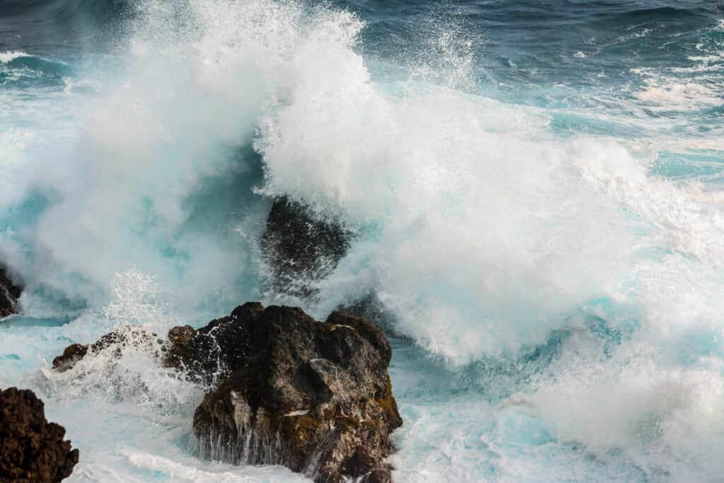 Waves crashing on lava rock at Waianapanapa State Park in Maui, Hawaii